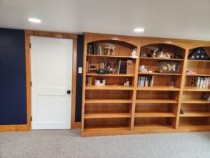 Room remodel with custom woodwork and built-in bookcase